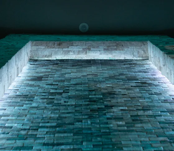 Control4 Vibrant linear lighting highlighting a textured stone wall