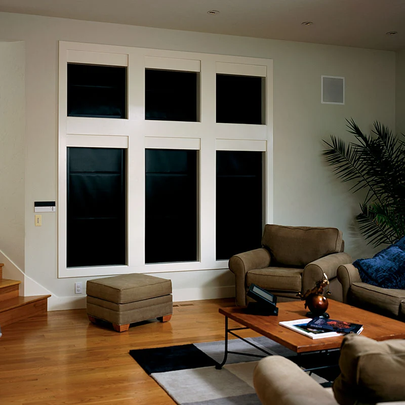 Draper LightBloc shades darkening a home media room